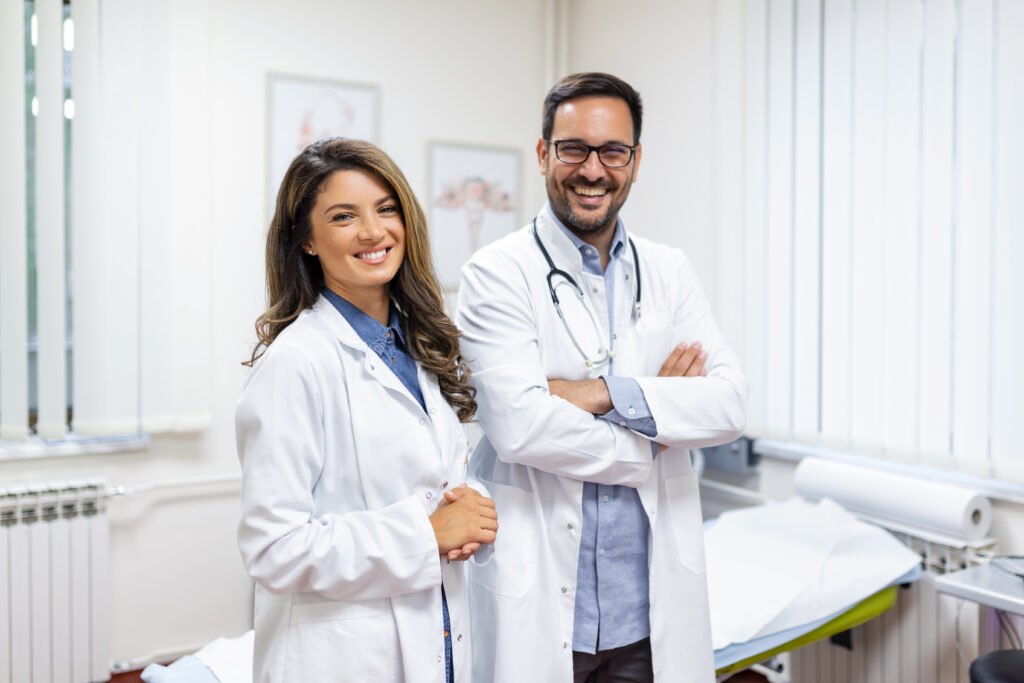 Smiling young doctors standing together in a modern hospital